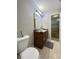 Bathroom featuring modern vanity with drawers, large mirror, and a toilet at 4925 Chip Shot Ln, Indianapolis, IN 46235