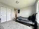 Bedroom with a bed, light gray carpet, and closet at 4925 Chip Shot Ln, Indianapolis, IN 46235