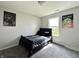 Bedroom with a bed, light gray carpet, window, and wall art at 4925 Chip Shot Ln, Indianapolis, IN 46235