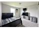 Bedroom with a black bed frame, TV, and light gray carpet at 4925 Chip Shot Ln, Indianapolis, IN 46235