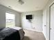 Bright bedroom with a neutral palette, large window, and closet at 4925 Chip Shot Ln, Indianapolis, IN 46235