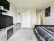 Bedroom with a TV, bed, light gray carpet, and closet at 4925 Chip Shot Ln, Indianapolis, IN 46235