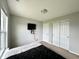 A cozy bedroom featuring neutral walls, a TV, and a comfortable bed at 4925 Chip Shot Ln, Indianapolis, IN 46235
