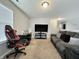 Comfortable bedroom with a cozy couch and a large television, perfect for relaxation and entertainment at 4925 Chip Shot Ln, Indianapolis, IN 46235