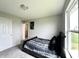 Bright bedroom with natural light from the window, complemented by neutral walls and a comfortable bed at 4925 Chip Shot Ln, Indianapolis, IN 46235