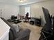 Bonus room with grey couch, desk, TV, and make up station at 4925 Chip Shot Ln, Indianapolis, IN 46235