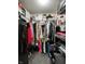 Organized walk-in closet with ample storage, clothing racks, and shelving units at 4925 Chip Shot Ln, Indianapolis, IN 46235