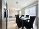Dining room features natural light and dark wood table and chairs at 4925 Chip Shot Ln, Indianapolis, IN 46235