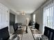 Dining room showcasing a set table with modern dishware, leading into a comfortable living area at 4925 Chip Shot Ln, Indianapolis, IN 46235
