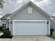 Attached two-car garage with a white door at 4925 Chip Shot Ln, Indianapolis, IN 46235