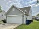 Detached garage with a white door and a well-maintained exterior at 4925 Chip Shot Ln, Indianapolis, IN 46235