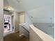 Bright hallway with view of the bathroom; the staircase leads to the lower level at 4925 Chip Shot Ln, Indianapolis, IN 46235