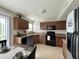 Well-lit kitchen features wooden cabinets and modern black appliances at 4925 Chip Shot Ln, Indianapolis, IN 46235