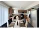 Eat-in kitchen features sleek black appliances and wood cabinets at 4925 Chip Shot Ln, Indianapolis, IN 46235