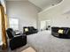 Bright living room with vaulted ceiling features plush seating and large windows with natural light at 4925 Chip Shot Ln, Indianapolis, IN 46235