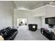 Open-concept living room with soaring ceiling and modern sofas offers a spacious and airy ambiance at 4925 Chip Shot Ln, Indianapolis, IN 46235