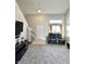Open-concept living room with high ceilings, large windows, and modern furnishings at 4925 Chip Shot Ln, Indianapolis, IN 46235