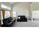 Inviting living room showcases high ceilings, neutral walls, and modern seating by large windows at 4925 Chip Shot Ln, Indianapolis, IN 46235