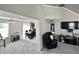 View of open living space featuring carpet and a black leather sofa, connecting to the dining area at 4925 Chip Shot Ln, Indianapolis, IN 46235