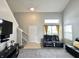 Large living room featuring high ceilings, natural light, and comfortable seating at 4925 Chip Shot Ln, Indianapolis, IN 46235
