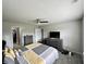 A large main bedroom features a closet, ceiling fan, gray walls and a plush bed at 4925 Chip Shot Ln, Indianapolis, IN 46235