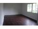 Bright bedroom with hardwood floors and a large window at 5 Tousley Ct, Indianapolis, IN 46224