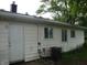 Rear exterior showcasing vinyl siding, newer windows, and back door entry for ease of access and comfort at 5 Tousley Ct, Indianapolis, IN 46224