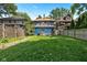 A spacious backyard featuring a well-maintained lawn and a charming two-story home with a deck at 552 Woodruff Pl W Dr, Indianapolis, IN 46201