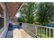 Outdoor balcony featuring wood decking, white railings, and seating to enjoy the surrounding greenery at 552 Woodruff Pl W Dr, Indianapolis, IN 46201