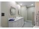 Elegant bathroom with double sinks, white cabinetry, and stylish mirrors at 552 Woodruff Pl W Dr, Indianapolis, IN 46201