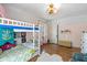 Playful ' bedroom with a white bunk bed, hardwood flooring and whimsical decorations at 552 Woodruff Pl W Dr, Indianapolis, IN 46201