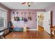 Bedroom with hardwood floors and five guitars hanging on the wall, plus other musical instruments at 552 Woodruff Pl W Dr, Indianapolis, IN 46201