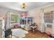 Charming bedroom with a bunk bed, hardwood floors, and delightful decor at 552 Woodruff Pl W Dr, Indianapolis, IN 46201