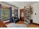 Inviting bedroom featuring a comfortable chair, hardwood floors, and a bookshelf at 552 Woodruff Pl W Dr, Indianapolis, IN 46201