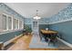 Elegant dining room featuring hardwood floors, blue wallpaper, and natural light from the windows at 552 Woodruff Pl W Dr, Indianapolis, IN 46201