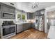 Updated kitchen with stainless steel appliances, gray cabinets, and subway tile backsplash at 552 Woodruff Pl W Dr, Indianapolis, IN 46201