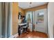 Bright home office with hardwood floors, a computer desk, and a door to a balcony at 552 Woodruff Pl W Dr, Indianapolis, IN 46201