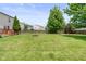 Large, manicured backyard with a firepit and a swing set at 5631 N Peppereel Way, McCordsville, IN 46055