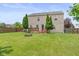 Large fenced backyard features a deck, fire pit, and lush green lawn for outdoor enjoyment at 5631 N Peppereel Way, McCordsville, IN 46055