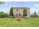 Expansive fenced backyard with a deck and fire pit, ideal for relaxation and entertaining at 5631 N Peppereel Way, McCordsville, IN 46055