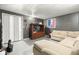 Finished basement with gray walls, painted floor, couch, and entertainment unit at 5631 N Peppereel Way, McCordsville, IN 46055