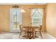 Charming dining area featuring a round wooden table with four chairs, near a window, and natural light at 5631 N Peppereel Way, McCordsville, IN 46055