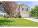 Inviting two-story home with a well-kept lawn, charming front porch, and attached two-car garage at 5631 N Peppereel Way, McCordsville, IN 46055