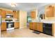 Functional kitchen features classic wood cabinets, modern appliances, and ample counter space for cooking at 5631 N Peppereel Way, McCordsville, IN 46055