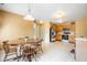 Open kitchen and dining area with wood cabinets, stainless steel appliances, and a classic wooden table set at 5631 N Peppereel Way, McCordsville, IN 46055