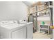 This laundry room features white appliances with an exposed hot water heater and plumbing at 5631 N Peppereel Way, McCordsville, IN 46055