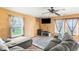 Comfortable living room featuring a ceiling fan, large sofa, and entertainment setup with a flat-screen TV at 5631 N Peppereel Way, McCordsville, IN 46055