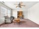Bright living room with ceiling fan, bookshelf, and comfortable seating area at 5631 N Peppereel Way, McCordsville, IN 46055