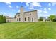 Lush green yard surrounds the rear of the home, complimented by neutral siding and natural sunlight at 5637 Woodland Trace Blvd, Indianapolis, IN 46237