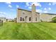 The spacious backyard offers a lush lawn with manicured stripes, perfect for outdoor activities and relaxation at 5637 Woodland Trace Blvd, Indianapolis, IN 46237